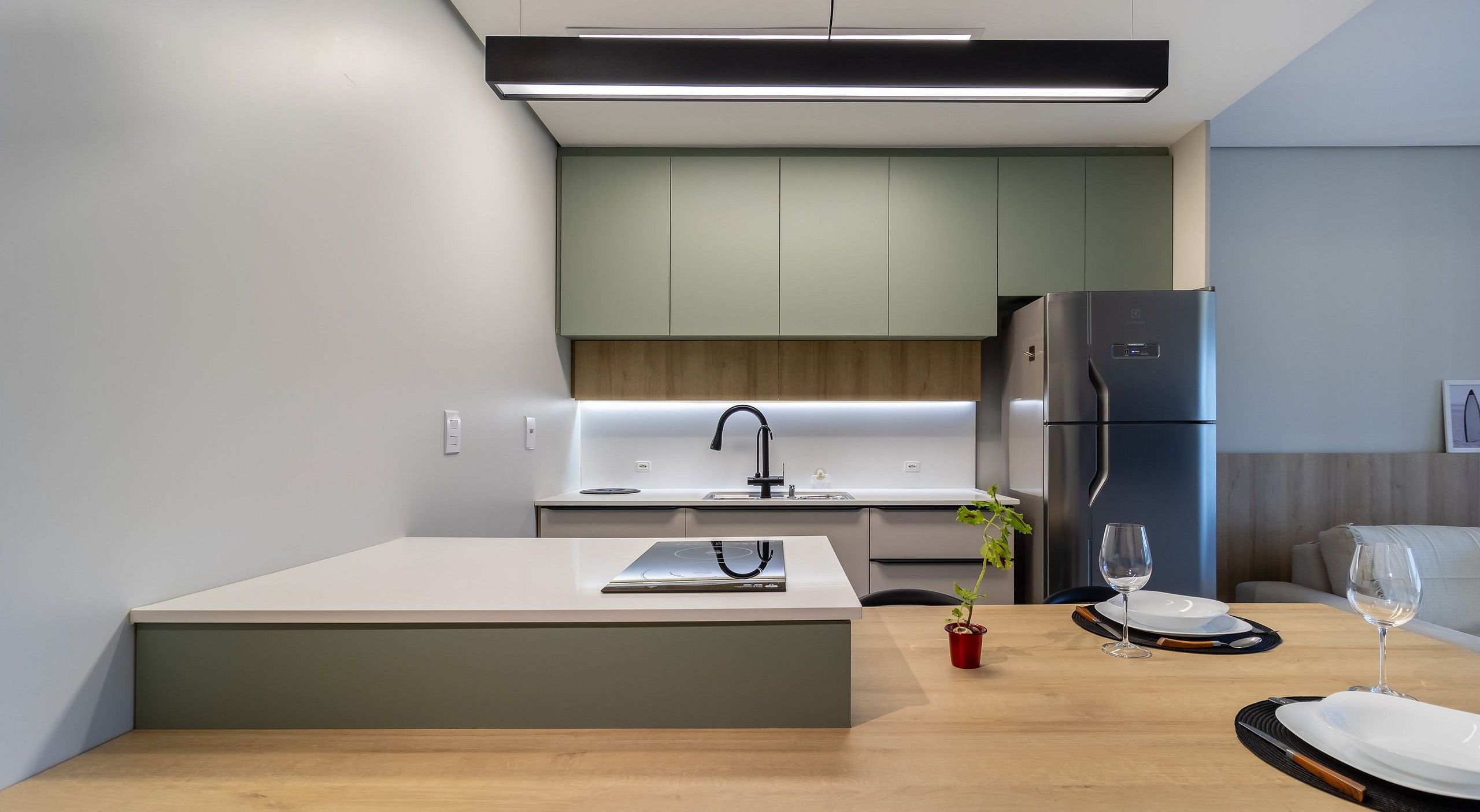 A modern kitchen with a central island, built-in appliances, and a minimalist design.