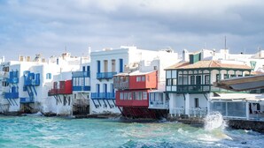 A coastal building with balconies and a view of the sea.