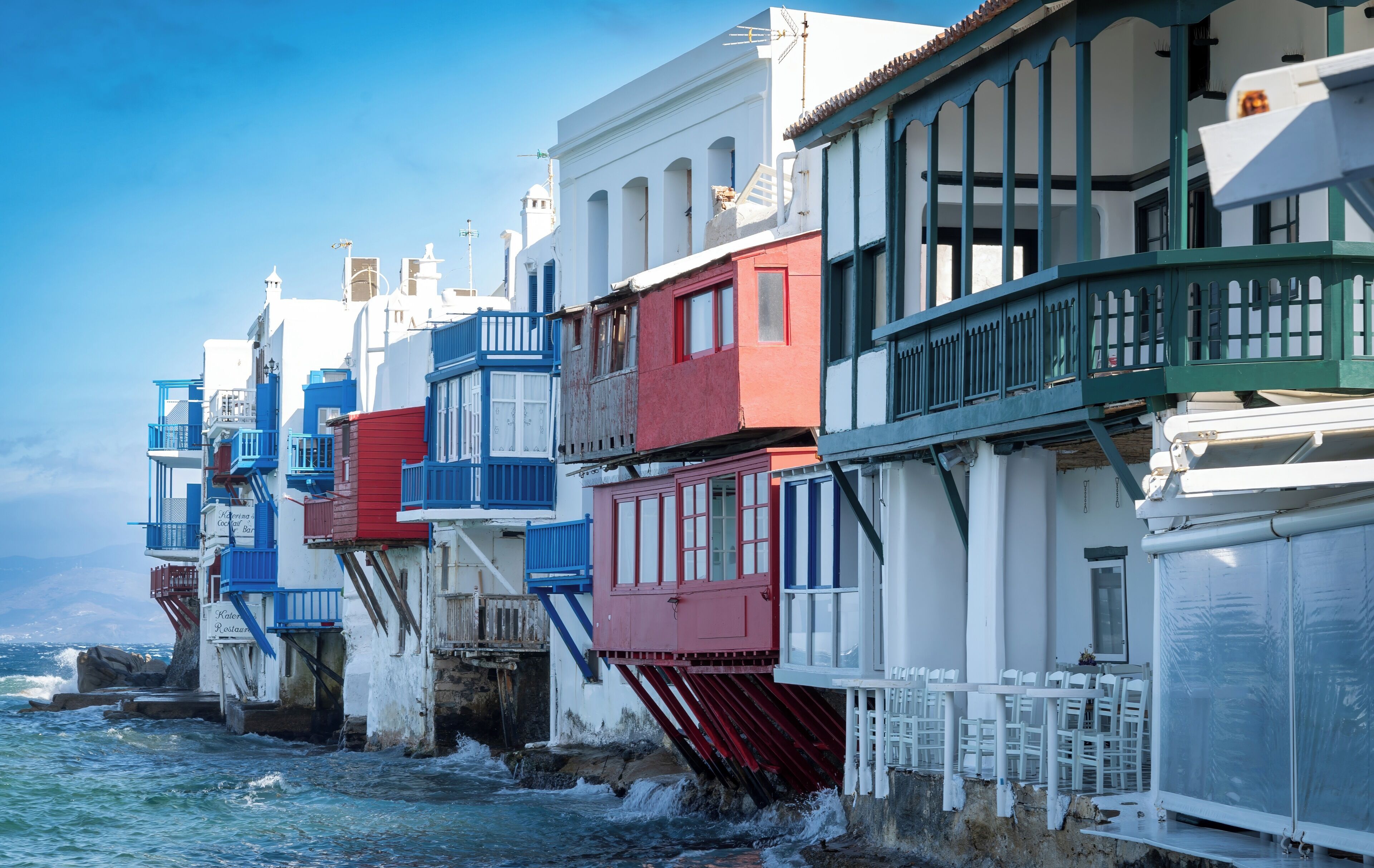 A coastal building with multiple balconies and a view of the sea.