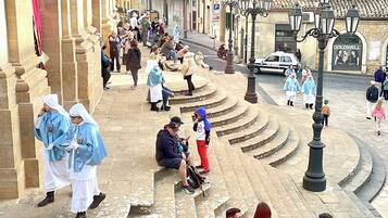 A public square with steps leading up to a building with classical architecture.