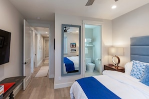 A hotel room with a bed, bedside table, and a mirror. - Rivervfront Upper Duplex w/ & Firepit on the Patio (Capitola)