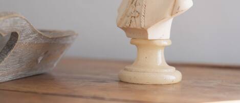 A bust sculpture on a wooden surface.