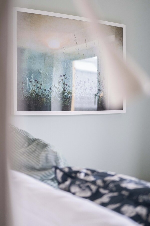 A bedroom with a bed, a framed picture on the wall, and a window. - Dough Beag 02 - 250m to the Prom! (Lahinch)