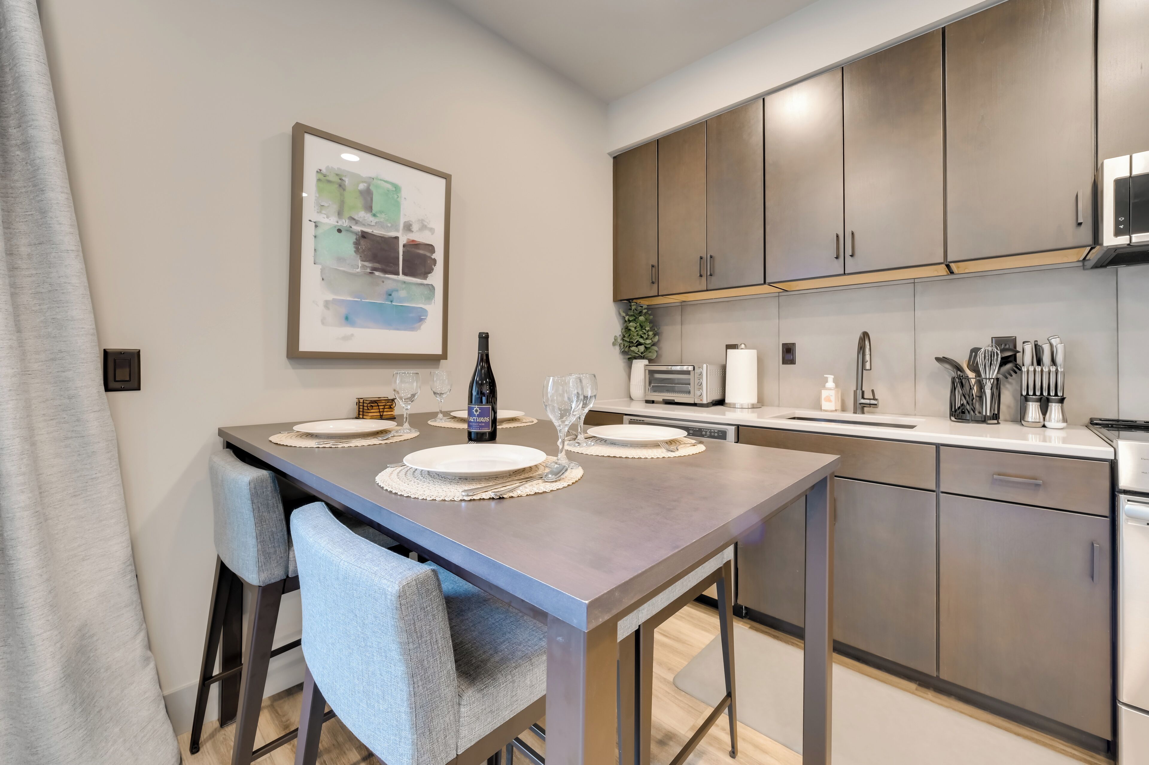 A modern kitchen with a dining area.