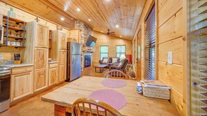 A wooden interior with a kitchen, dining area, and seating space. - Broken Bow Cabin: Hot Tub, Fire Pit & 7 Mi to Lake (Broken Bow)