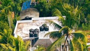 An aerial view of a residential property with a large house, a swimming pool, and surrounding palm trees. - This is a 7-room Lakeside villa with a beautiful view and lawn.  (Kochi)