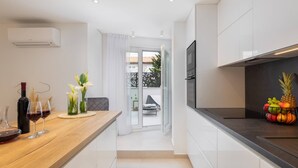 A modern kitchen with a wooden countertop, a built-in oven, and a fruit bowl. - Luxury Apartment Silvery Split with Sauna, Jacuzzi (Split)