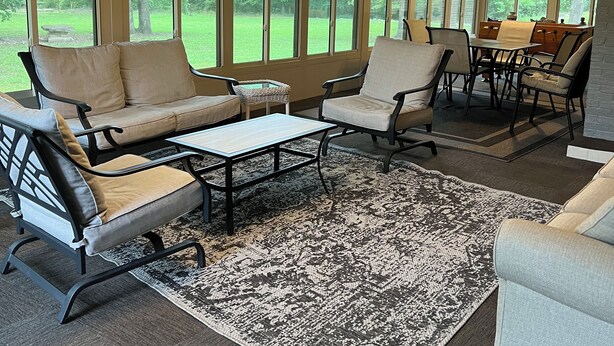A covered patio with a dining table, chairs, and a sofa. - Beautiful large home on Lake Chickamauga at Dallas Bay with private boat ramp. (Middle Valley)