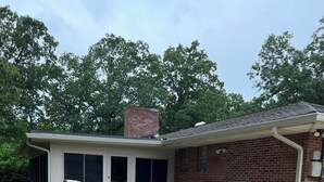 A single-story house with a patio area, a brick chimney, and a covered entryway. - Beautiful large home on Lake Chickamauga at Dallas Bay with private boat ramp. (Middle Valley)