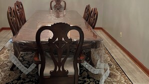 A dining room with a long table, chairs, a chandelier, and a framed picture on the wall. - Beautiful large home on Lake Chickamauga at Dallas Bay with private boat ramp. (Middle Valley)