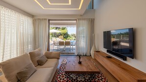 A modern living room with a sofa, coffee table, and TV. - Villa Oleander Zadarvillas (Zadar)