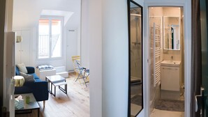 A modern apartment with a living room, a dining area, and a bathroom. - 1 bedroom apartment in paris (Paris)