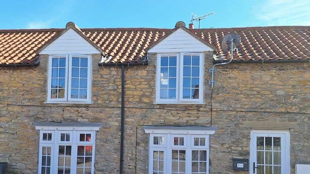 A stone building with a tiled roof, multiple windows, and a door. - Lavender Cottage - a beautiful quirky cottage (Snainton)