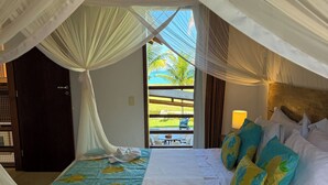 A room with a bed, white curtains, and a view of the outdoors. - House 4 suites, swimming pool, views of the sea and golf course. Turtle Beach  (Trancoso)