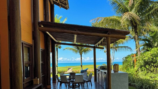 A covered outdoor seating area with a view of the ocean. - House 4 suites, swimming pool, views of the sea and golf course. Turtle Beach  (Trancoso)
