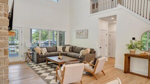 TV, fireplace - Whispering Pines Estate, Waterfront Luxury w/ Covered Verandas + Heated Salt Pool, Hot Tub, Dock! (Bedford County)