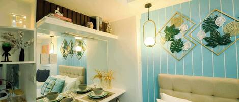 A modern bedroom with a bed, bedside table, and a mirror.