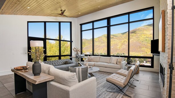 A spacious living room with large windows, a fireplace, and a modern design. - Sequoia Chalet | 5BR Vail Luxury Retreat, AC, Hot Tub, Views (Vail)