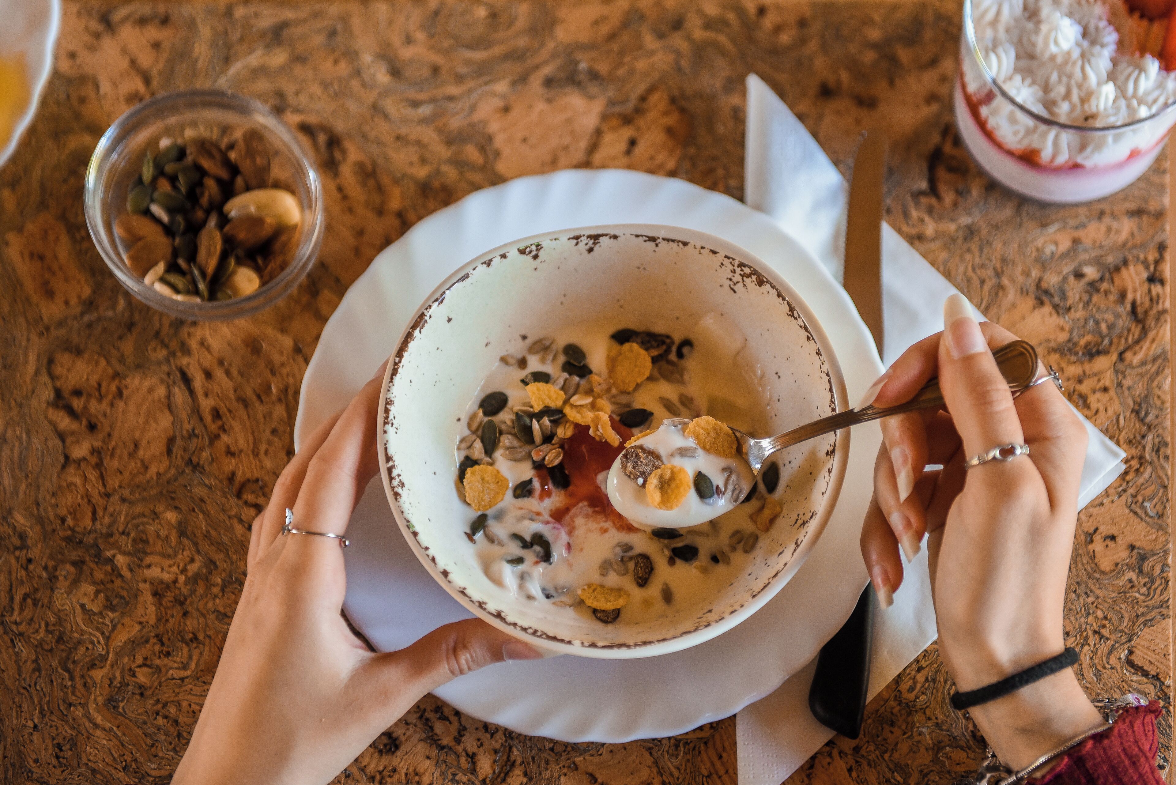 A bowl of cereal with milk and toppings on a table.
