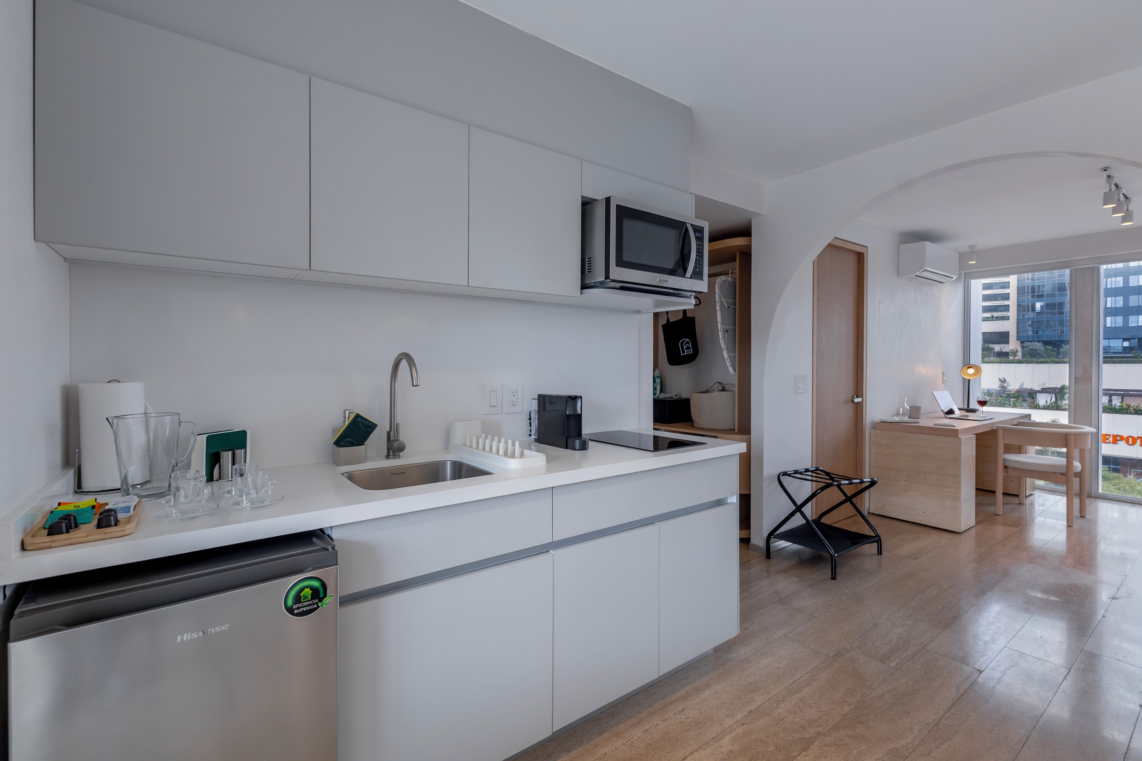 A modern kitchen with a dishwasher, microwave, and sink.