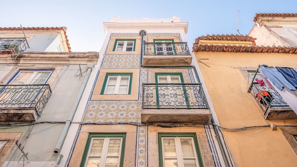 A multi-story building with balconies, patterned tiles, and a clear sky. - Bairro Alto Prime Studio I by Homing (Lisbon)