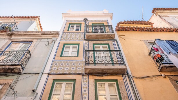 A multi-story building with balconies, patterned tiles, and a clear sky. - Bairro Alto Prime Studio II by Homing (Lisbon)