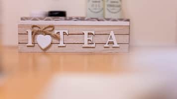 A wooden block with the letters "I HEART TEA" and a heart-shaped decoration.