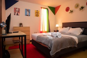 A bedroom with a bed, a desk, a TV, and a dresser. - Downtown Apt Walk Everywhere Clean Safe (Pittsburgh)