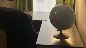A desk with a globe and a lamp, a chair, and a window with curtains. - 2bedroom 2bathroom Apt Downtown Walk Anywhere (Pittsburgh)