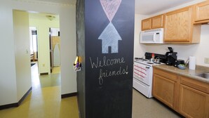 A kitchen with wooden cabinets, a microwave, and a stove. - 2 Bedroom 2 Bath City Views (Pittsburgh)