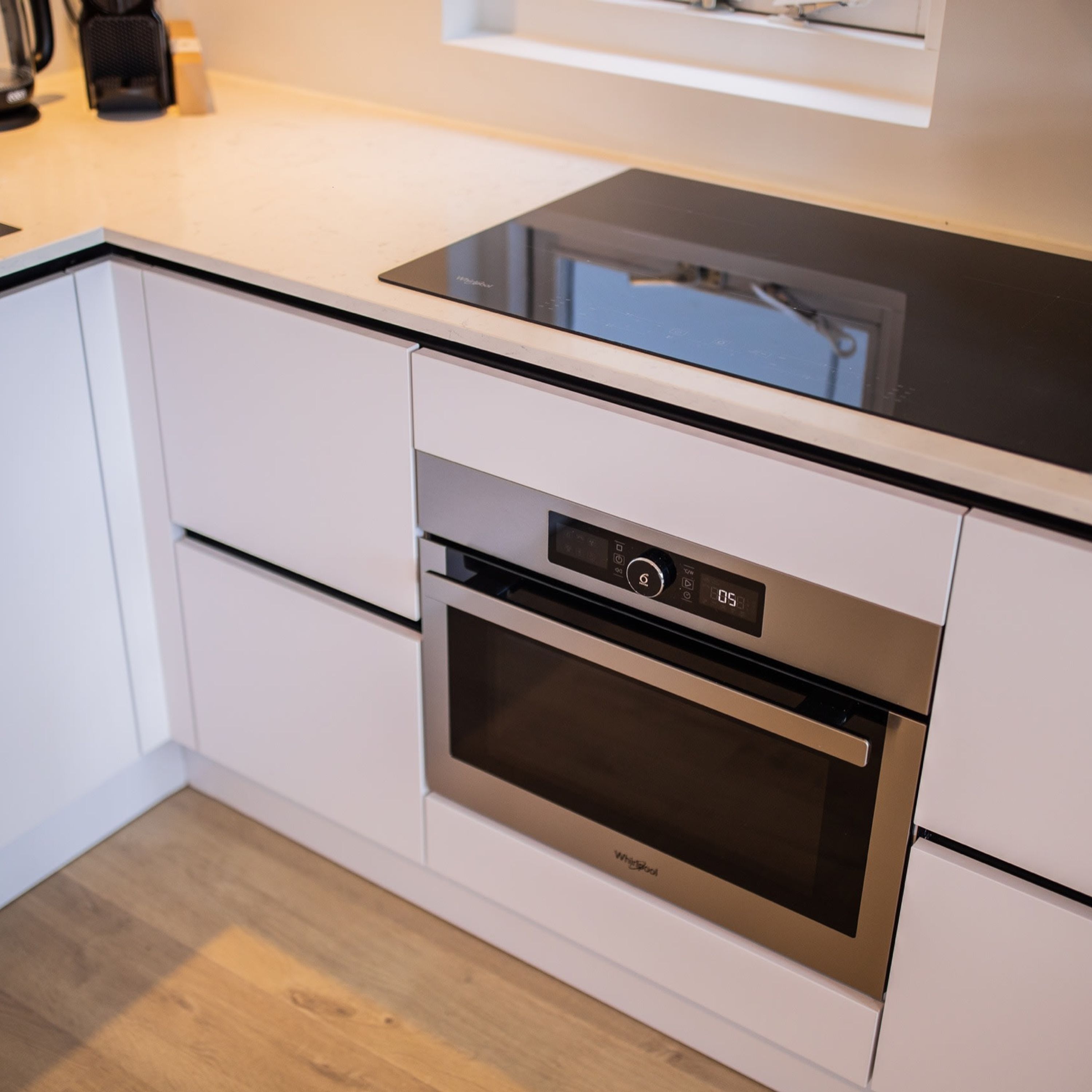 A modern kitchen with a built-in oven and a digital control panel.