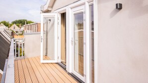 A modern apartment with a balcony, large sliding glass doors, and a view of neighboring houses. - Nb306 Serviced Apartment 2,5br (Rotterdam)