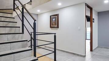 A staircase with a modern design, leading to an upper floor.