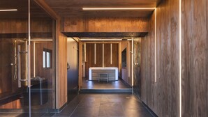 A modern bathroom with a glass shower enclosure, a wooden vanity, and a large bathtub. - Richmond Place - Apartment in Private Mansion (Kendal)