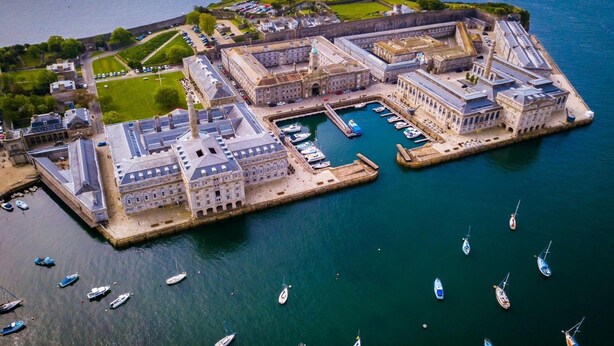 An aerial view of a historic port with a fortified structure, a marina with several boats, and surrounding greenery. - Two-bedroom Apartment at Royal William Yard (Plymouth)