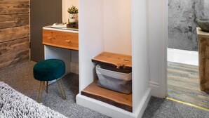 A modern bathroom with a wooden vanity, a green stool, and a shower enclosure. - Windermere Central Hotel - Room 1 (Windermere)