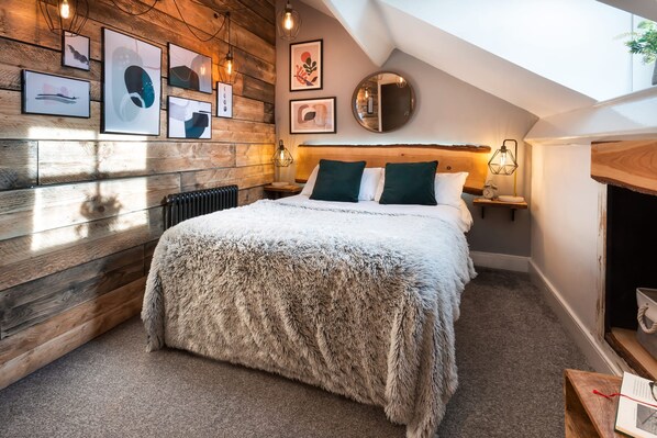 Um quarto aconchegante com parede de madeira, cama macia e claraboia.