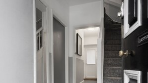 A hallway with a carpeted floor, a staircase, and a door labeled "LETTERBOX". - Windermere Central Hotel - Room 4 (Windermere)