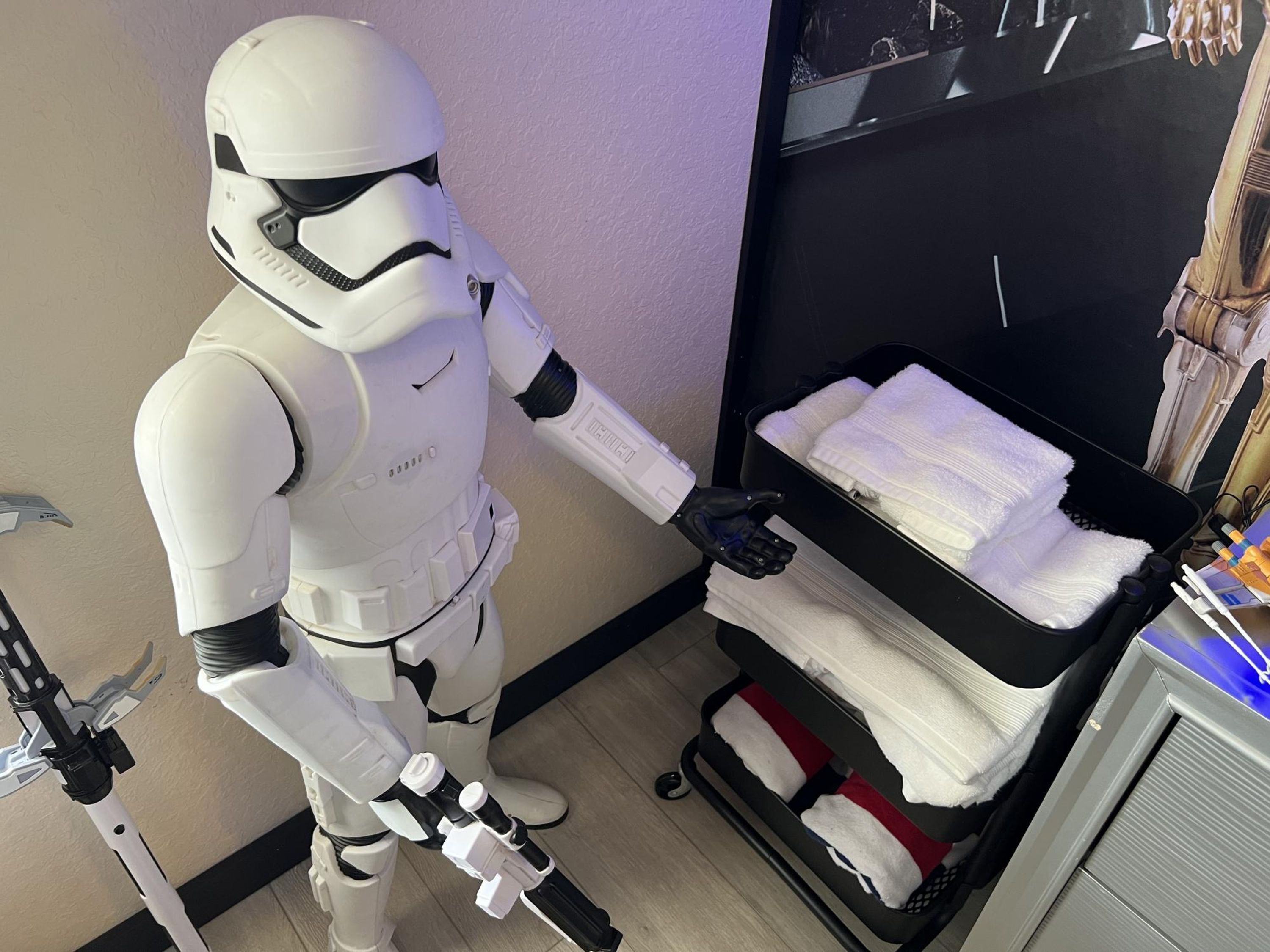 A room with a bed, a nightstand, and a suitcase.