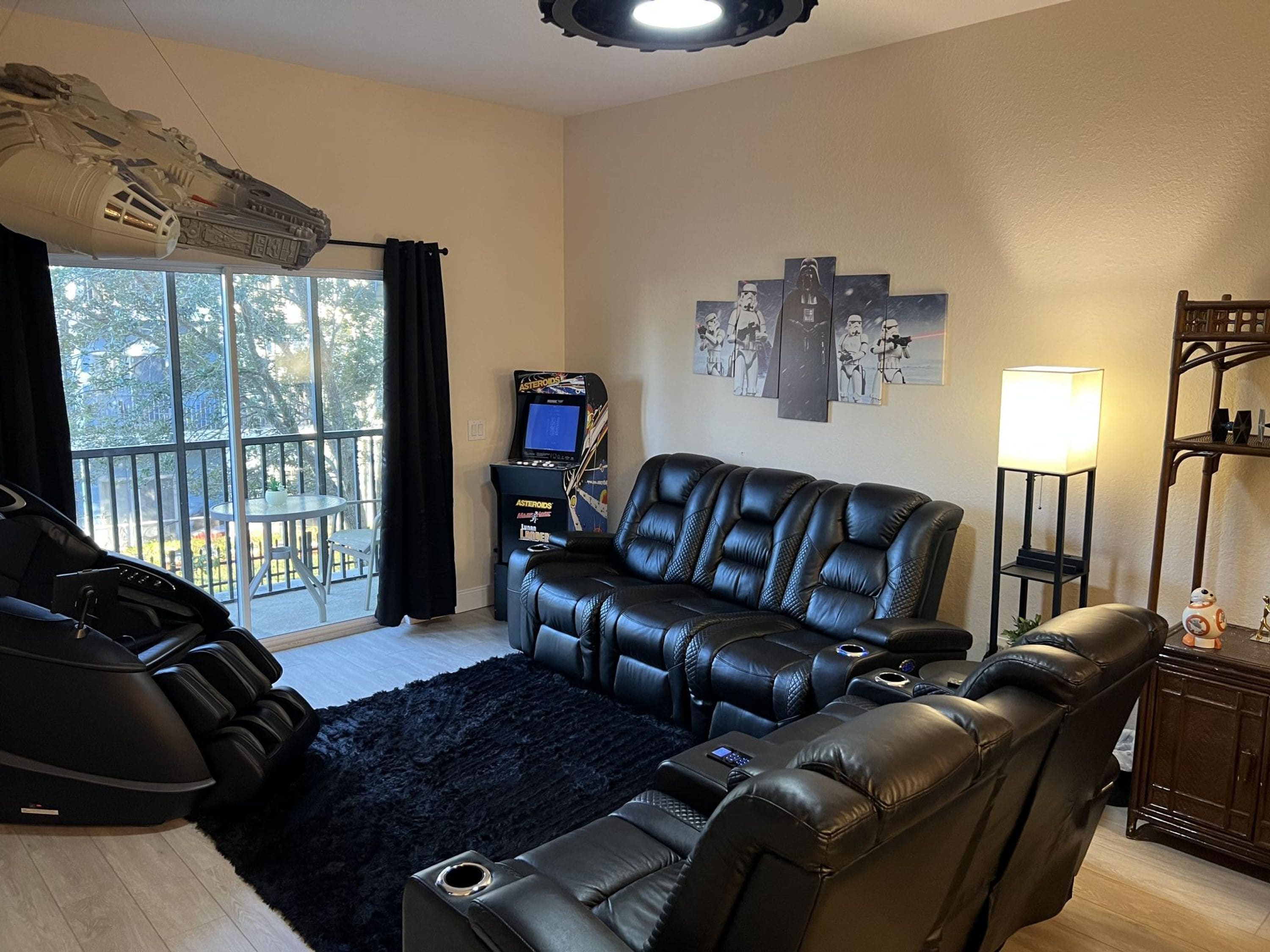 A living room with a black leather sofa, a massage chair, a massage table, a massage machine, a massage table, a massage machine, a massage table, a massage machine, a massage table, a massage machine, a massage table, a massage machine, a massage table, a massage machine, a massage table, a massage machine, a massage table, a massage machine, a massage table, a massage machine, a massage table, a massage machine, a massage table, a massage machine, a massage table, a massage machine, a massage table, a massage machine, a massage table, a massage machine, a massage table, a massage machine, a massage table, a massage machine, a massage table, a massage machine, a massage table, a massage machine, a massage table, a massage machine, a massage table, a massage machine, a massage table, a massage machine, a massage table, a massage machine, a massage table, a massage machine,