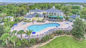 A large house with a swimming pool, surrounded by palm trees and a fence. - Disney Area Grnd Floor Park Free (Davenport)