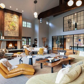 Cozy living area with a fireplace, plush sofa, and armchairs, perfect for relaxing.