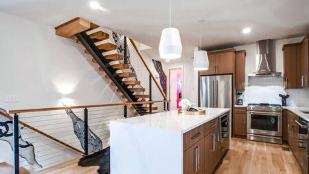 A modern kitchen with wooden cabinets, a stainless steel refrigerator, and a built-in oven. - Music Fame House Gulch 4 Patios View Karaoke (Nashville)