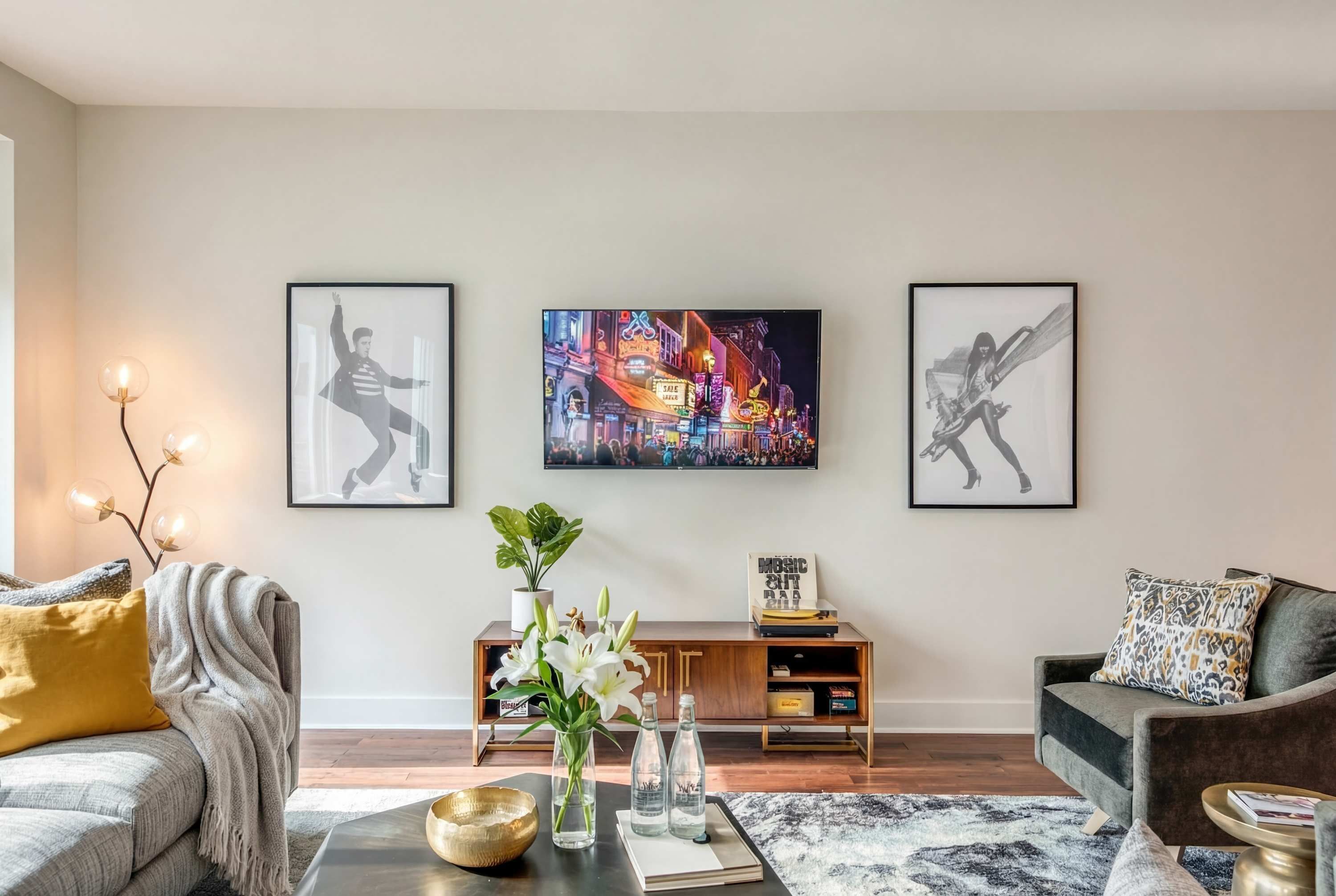 A living room with a sofa, coffee table, and artwork on the wall.