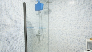 A bathroom with a shower, toilet, and sink. - Windhouse  (Imsouane)