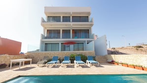 A modern two-story building with a swimming pool in front. - Windhouse  (Imsouane)