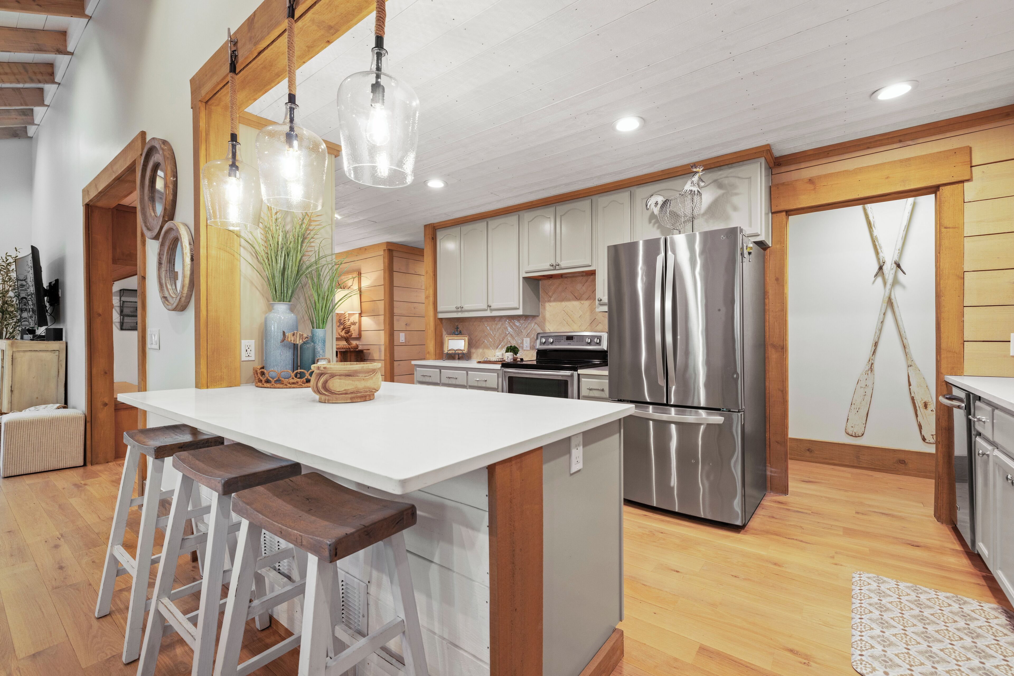 A spacious kitchen with a large island, stainless steel appliances, and wooden accents.