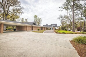 A building with a covered walkway and a paved driveway.