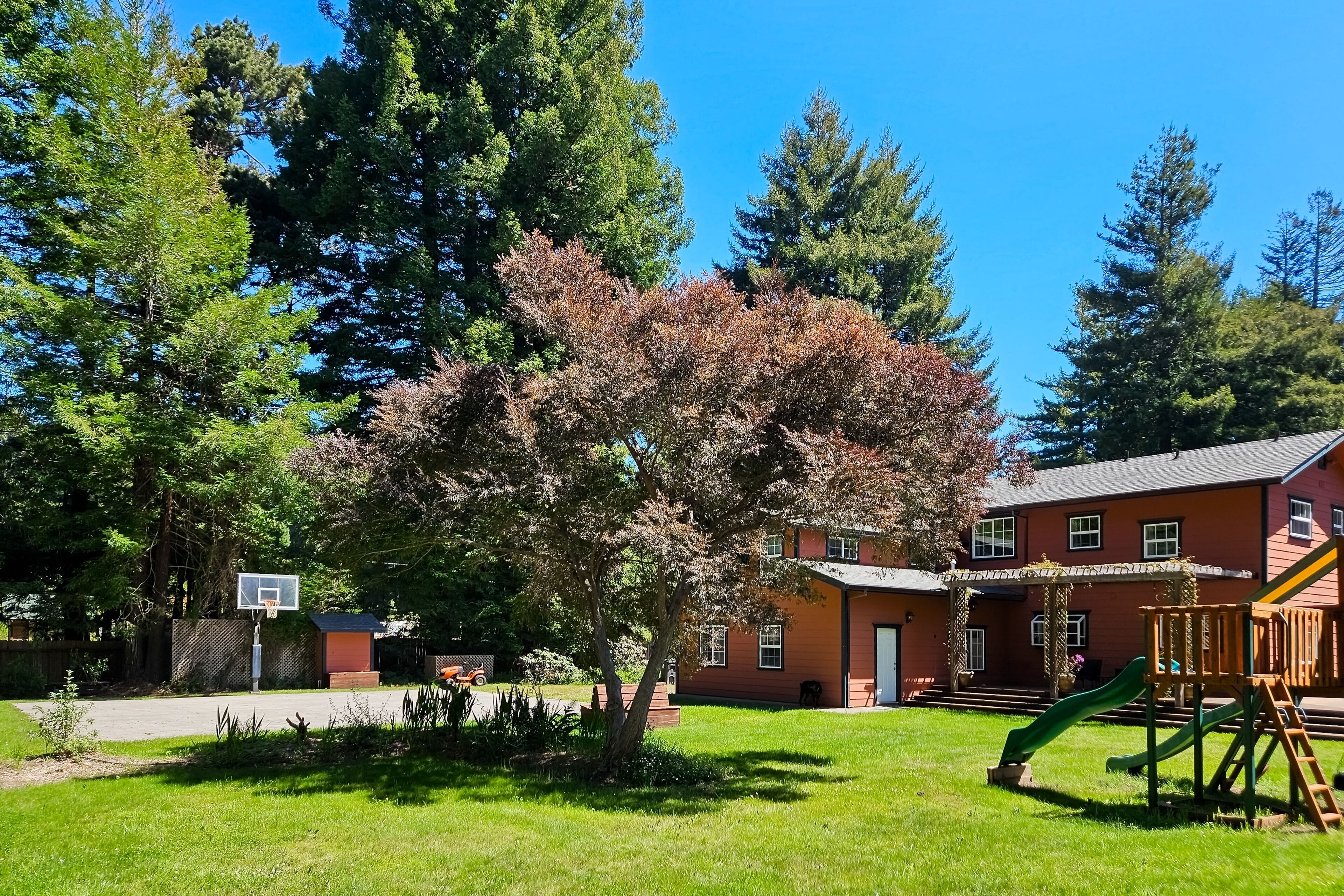 Magical estate & detached guest suite with hot tub, game room, pond & playset