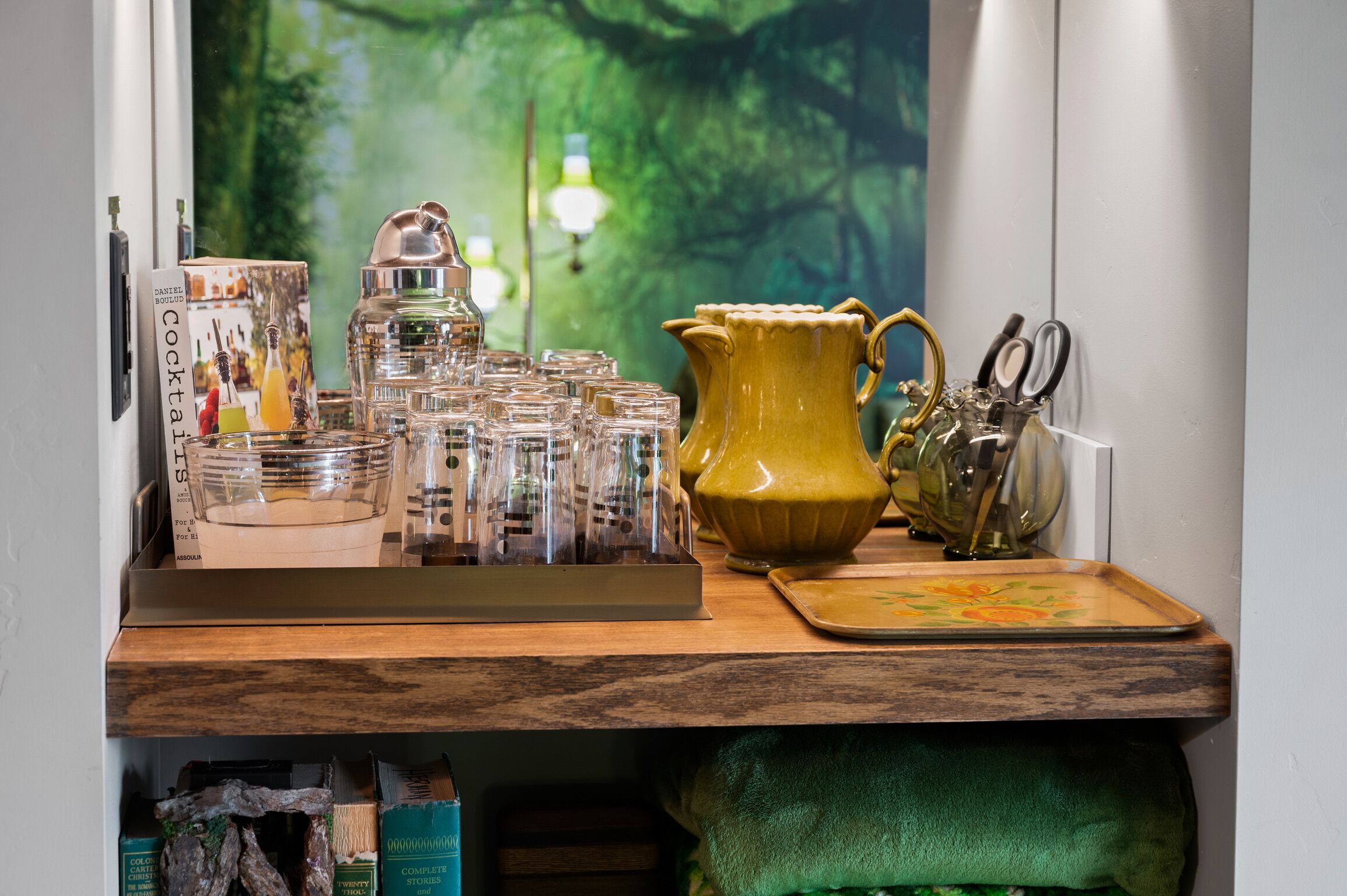 A kitchen counter with a coffee machine, a yellow pitcher, and a set of kitchen utensils.